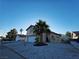 Charming two-story home featuring a two-car garage and low-maintenance desert landscaping with a mature palm tree at 6746 Shelter Ln, Las Vegas, NV 89103