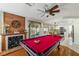 Game room with pool table, fireplace, and backyard access, flowing into the kitchen and dining area at 6746 Shelter Ln, Las Vegas, NV 89103