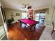 Entertaining game room featuring a well-lit pool table and a cozy fireplace with stylish draperies at 6746 Shelter Ln, Las Vegas, NV 89103