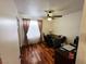Cozy home office featuring hardwood floors, a ceiling fan, and a wooden desk with a view of the exterior at 6746 Shelter Ln, Las Vegas, NV 89103