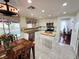 Cozy kitchen featuring white cabinets, tile backsplash, and a butcher block island with a dining area at 6746 Shelter Ln, Las Vegas, NV 89103