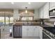 Well-lit kitchen with stainless steel appliances, granite countertops, and a backyard view at 6746 Shelter Ln, Las Vegas, NV 89103