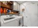 Functional laundry room with updated appliances, storage cabinets, and a folding area at 6746 Shelter Ln, Las Vegas, NV 89103