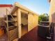 Exterior view of backyard outbuilding showcasing painted door and exterior shelving at 6746 Shelter Ln, Las Vegas, NV 89103