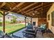 Covered patio with comfortable seating and a built-in outdoor kitchen area perfect for entertaining at 6746 Shelter Ln, Las Vegas, NV 89103
