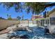 Wide shot of backyard and surrounding fence with trees in the background at 6822 Garden Grove Ave, Las Vegas, NV 89103