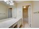 Bright bathroom featuring a single sink vanity with large mirror and a separate bathtub at 6822 Garden Grove Ave, Las Vegas, NV 89103