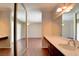 Bathroom with double sink vanity and large mirror, with access to a bedroom at 6822 Garden Grove Ave, Las Vegas, NV 89103