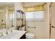 Bathroom featuring a shower, toilet, and sink with chrome faucet fixtures at 6822 Garden Grove Ave, Las Vegas, NV 89103
