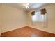 Bedroom featuring hardwood floors, ceiling fan, and bright windows with curtains at 6822 Garden Grove Ave, Las Vegas, NV 89103