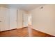 Bright bedroom features hardwood flooring and a closet with sliding doors at 6822 Garden Grove Ave, Las Vegas, NV 89103