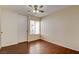 A cozy bedroom with hardwood floors and a ceiling fan at 6822 Garden Grove Ave, Las Vegas, NV 89103