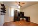 Cozy bedroom featuring ceiling fan, installed shelving and desk at 6822 Garden Grove Ave, Las Vegas, NV 89103