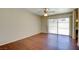 Bedroom featuring hardwood floors, ceiling fan and a sliding glass door at 6822 Garden Grove Ave, Las Vegas, NV 89103
