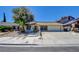 Charming single-story home with desert landscaping, long driveway, and an attached two-car garage at 6822 Garden Grove Ave, Las Vegas, NV 89103