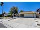Charming single-story home with desert landscaping, long driveway, and an attached two-car garage at 6822 Garden Grove Ave, Las Vegas, NV 89103