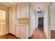 Hallway with hardwood floors, built in cabinets, and an access to a laundry room at 6822 Garden Grove Ave, Las Vegas, NV 89103