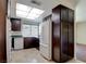 The kitchen features wood cabinets and tile flooring at 6822 Garden Grove Ave, Las Vegas, NV 89103
