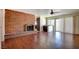 A living room featuring a brick fireplace and a sliding door to the back at 6822 Garden Grove Ave, Las Vegas, NV 89103