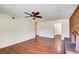 A living room featuring a brick fireplace and hardwood floors at 6822 Garden Grove Ave, Las Vegas, NV 89103