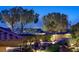 Expansive property featuring pool, firepit, custom stonework, desert landscaping, and city views at 69 Tapadero Ln, Las Vegas, NV 89135
