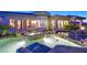 Stunning backyard pool and spa area features natural rock accents and seamless integration with the home's architecture at 69 Tapadero Ln, Las Vegas, NV 89135