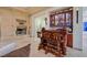 Elegant bar area boasts custom cabinetry, a stone fireplace, and comfortable seating for entertaining guests at 69 Tapadero Ln, Las Vegas, NV 89135