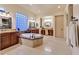 Luxurious bathroom featuring dual sinks, tiled flooring, soaking tub with marble accents and a blue block glass window at 69 Tapadero Ln, Las Vegas, NV 89135