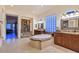 Large bathroom boasts dual vanities, garden tub, travertine flooring, and natural light at 69 Tapadero Ln, Las Vegas, NV 89135