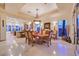 Spacious dining room features a chandelier, backyard views, and an open floor plan at 69 Tapadero Ln, Las Vegas, NV 89135