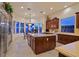 Modern kitchen features an island, stainless appliances, breakfast nook and many windows at 69 Tapadero Ln, Las Vegas, NV 89135
