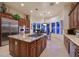 Gourmet kitchen boasts granite counters, stainless appliances, and a central island cooktop at 69 Tapadero Ln, Las Vegas, NV 89135