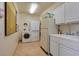 Spacious laundry room with washer, dryer, sink, and plenty of cabinet space at 69 Tapadero Ln, Las Vegas, NV 89135