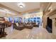 Spacious living room with a large sectional couch, fireplace, and travertine floors at 69 Tapadero Ln, Las Vegas, NV 89135