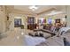 Open concept living area features a large sectional couch, bar area and fireplace at 69 Tapadero Ln, Las Vegas, NV 89135