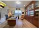 Cozy office with custom wooden built-ins, hardwood floors, and natural light from the backyard at 69 Tapadero Ln, Las Vegas, NV 89135