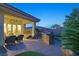 Outdoor kitchen and covered patio area, ideal for grilling and outdoor dining experiences at 69 Tapadero Ln, Las Vegas, NV 89135