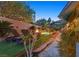Backyard oasis featuring a custom pool with rock features, fire pit, and lounge chairs at 69 Tapadero Ln, Las Vegas, NV 89135
