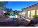 Stunning outdoor space with a rock waterfall, pool, and fire pit at 69 Tapadero Ln, Las Vegas, NV 89135
