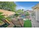 Outdoor oasis featuring a custom pool, stone features, fire pit and lush landscaping at 69 Tapadero Ln, Las Vegas, NV 89135