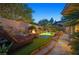 Backyard retreat with a rock waterfall pool, fire pit, and ample space for relaxation at 69 Tapadero Ln, Las Vegas, NV 89135