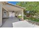 Relaxing back patio with ceiling fan and a well shaded grassy area at 6920 Haven Hollow Ave, Las Vegas, NV 89130