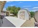 Private backyard with a shed, manicured landscaping, a covered patio, and ample room for outdoor activities at 6920 Haven Hollow Ave, Las Vegas, NV 89130
