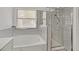 Well-lit bathroom featuring modern shower, tub, and neutral tile surround at 6920 Haven Hollow Ave, Las Vegas, NV 89130