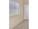 Bright bedroom boasting a large window, neutral walls and carpet and white trim at 6920 Haven Hollow Ave, Las Vegas, NV 89130