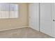 Bedroom featuring carpet, a window with blinds, and a closet with white double doors at 6920 Haven Hollow Ave, Las Vegas, NV 89130
