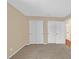 Spacious bedroom with carpet, neutral walls, a window, and double closets for ample storage at 6920 Haven Hollow Ave, Las Vegas, NV 89130