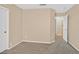 Cozy bedroom featuring neutral walls, plush carpeting, and white trim with an open doorway to another room at 6920 Haven Hollow Ave, Las Vegas, NV 89130