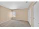 Bedroom with plush carpet, neutral walls, a window for natural light, and a closet with double doors at 6920 Haven Hollow Ave, Las Vegas, NV 89130