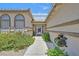 Inviting front entrance with a tiled roof, colorful flowers, and walkway leading to the front door at 6920 Haven Hollow Ave, Las Vegas, NV 89130